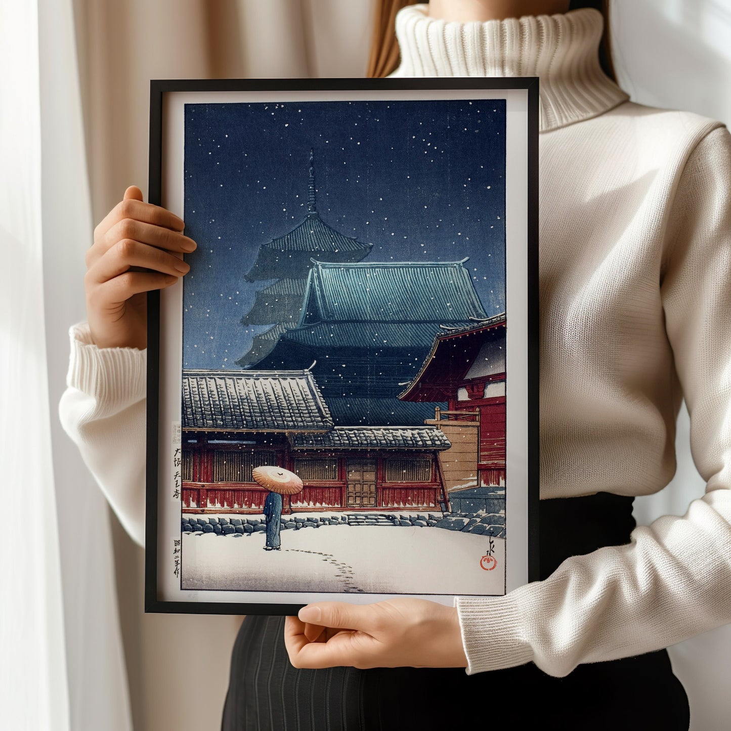 Woman holding framed Kawase Hasui Tenno Temple Osaka print, vintage Japanese woodcut art, available framed or unframed.