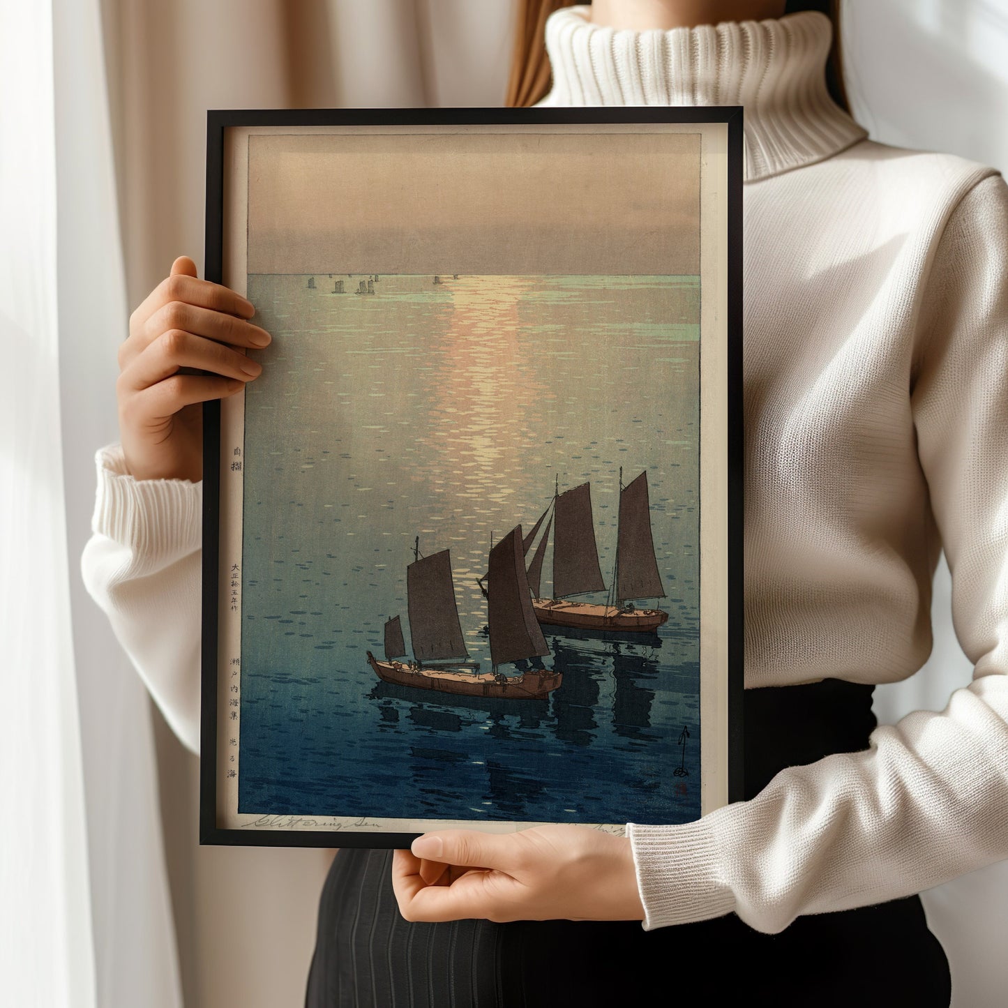 Framed Hiroshi Yoshida sailboats print held, showcasing vintage Japanese woodblock art in elegant frame.