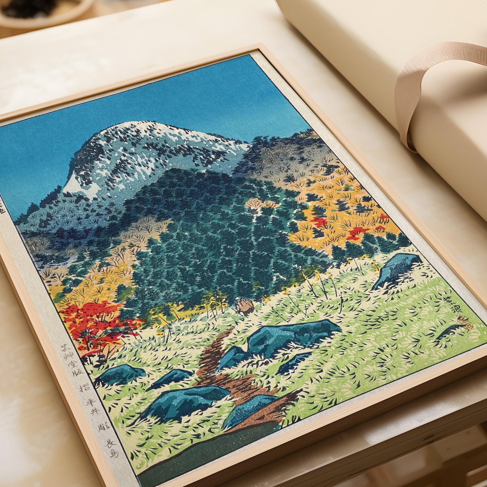 Shiro Kasamatsu Mount Kasugatake art print, vintage Japanese Shin-Hanga Kachō-E, framed on table with packaging nearby.