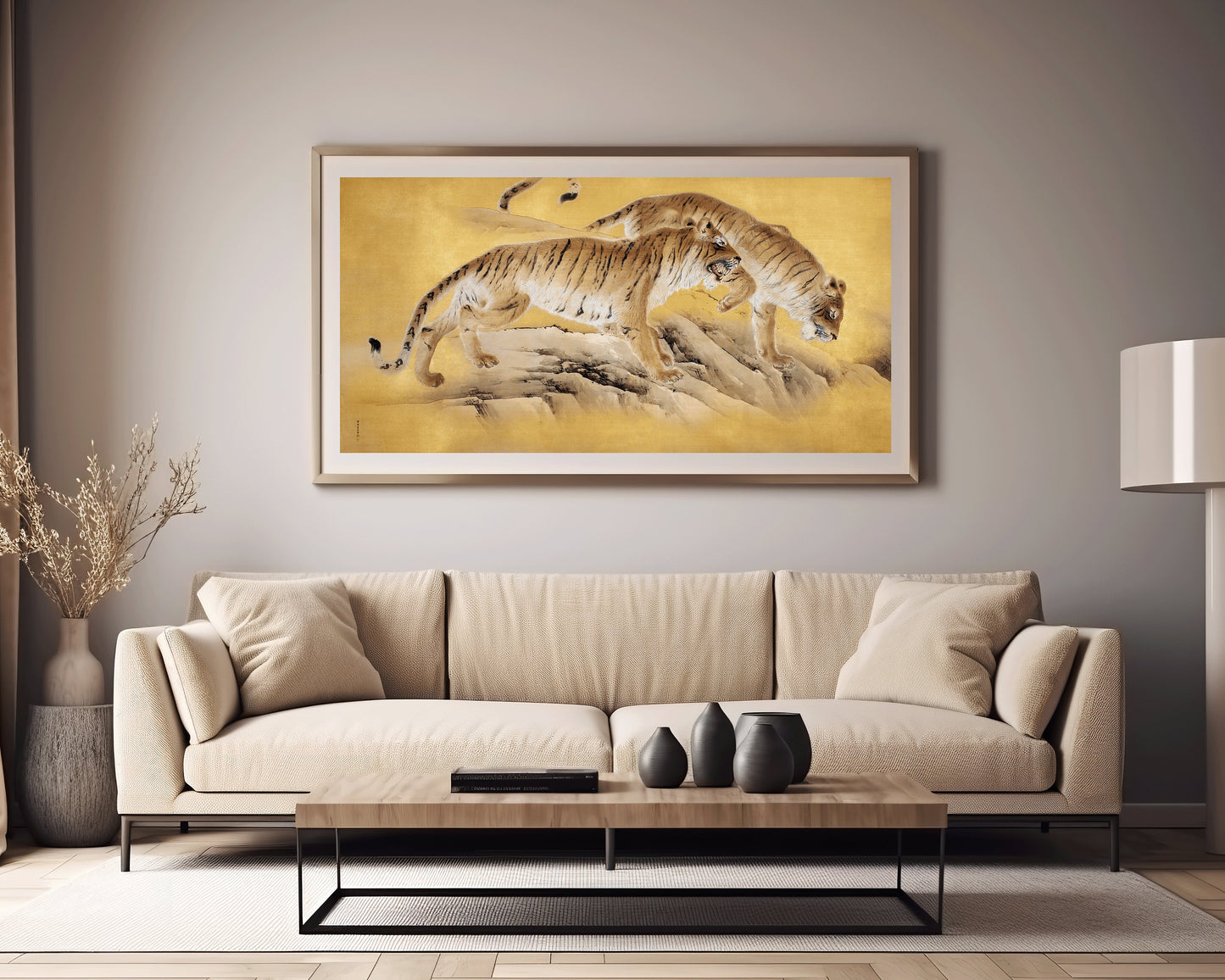 Vintage Asian art of tigers by a mountain stream in a gold frame, enhancing a modern living room above a beige sofa.