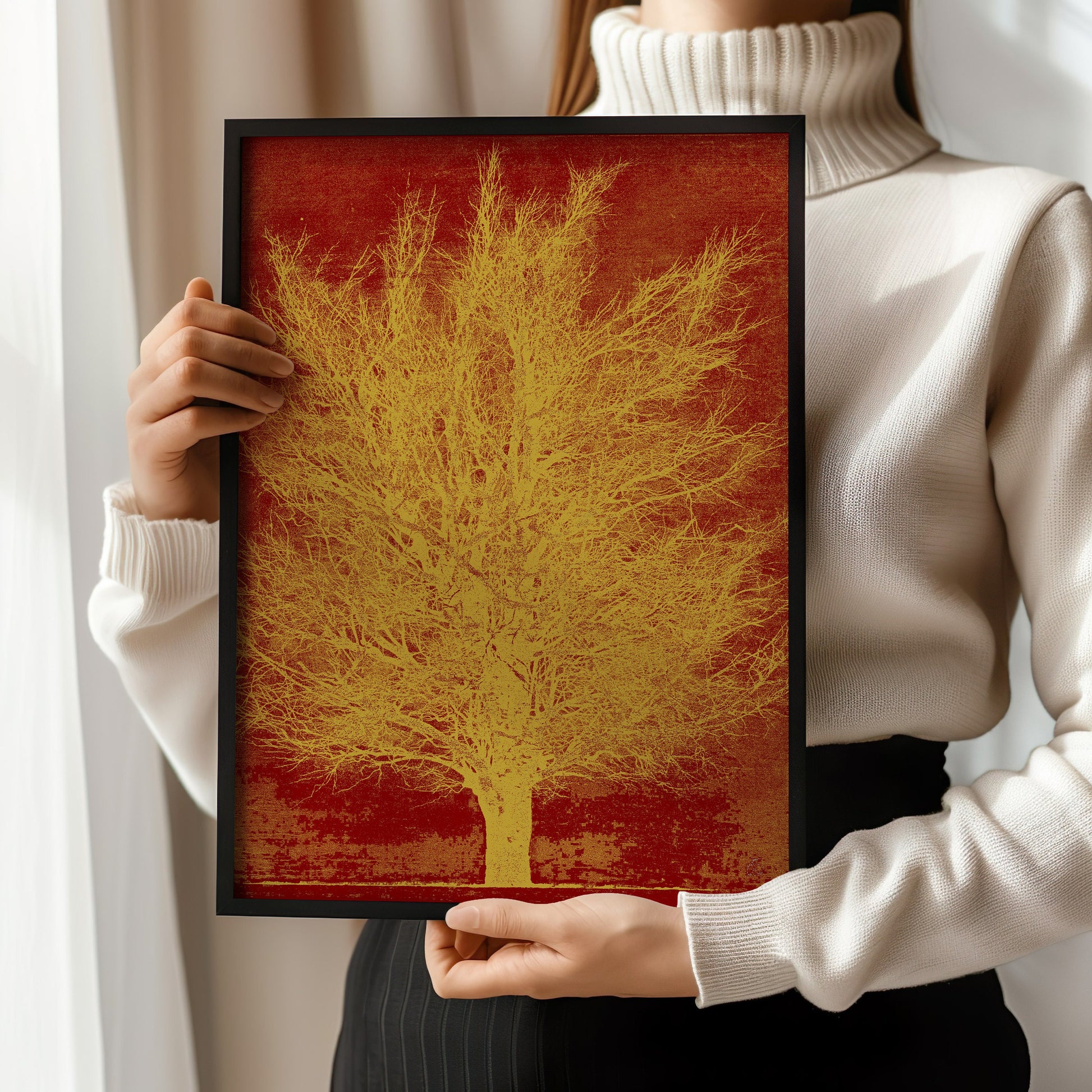 Woman holding a framed Joichi Hoshi Gold Tree print, showcasing vintage Japanese woodblock art in a modern setting.