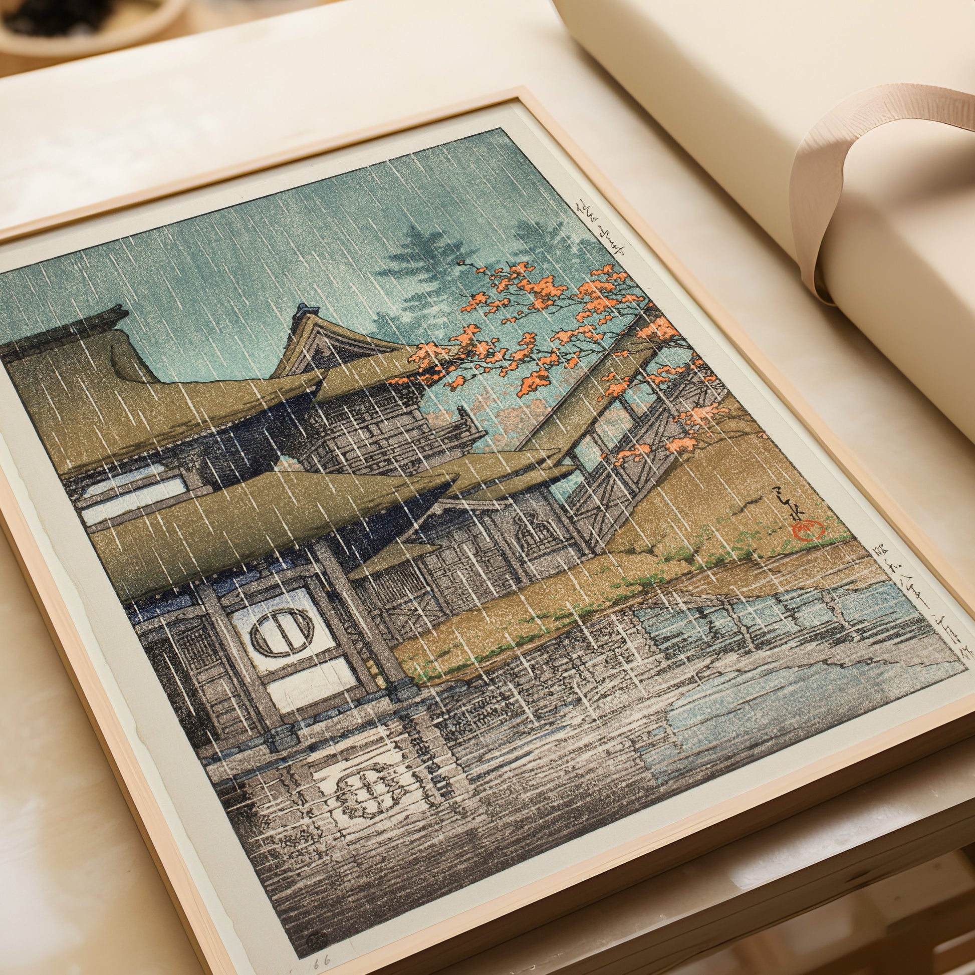 Kawase Hasui Mountain Temple at Senzai framed woodblock art print on table, rain scene, available in bespoke frames.