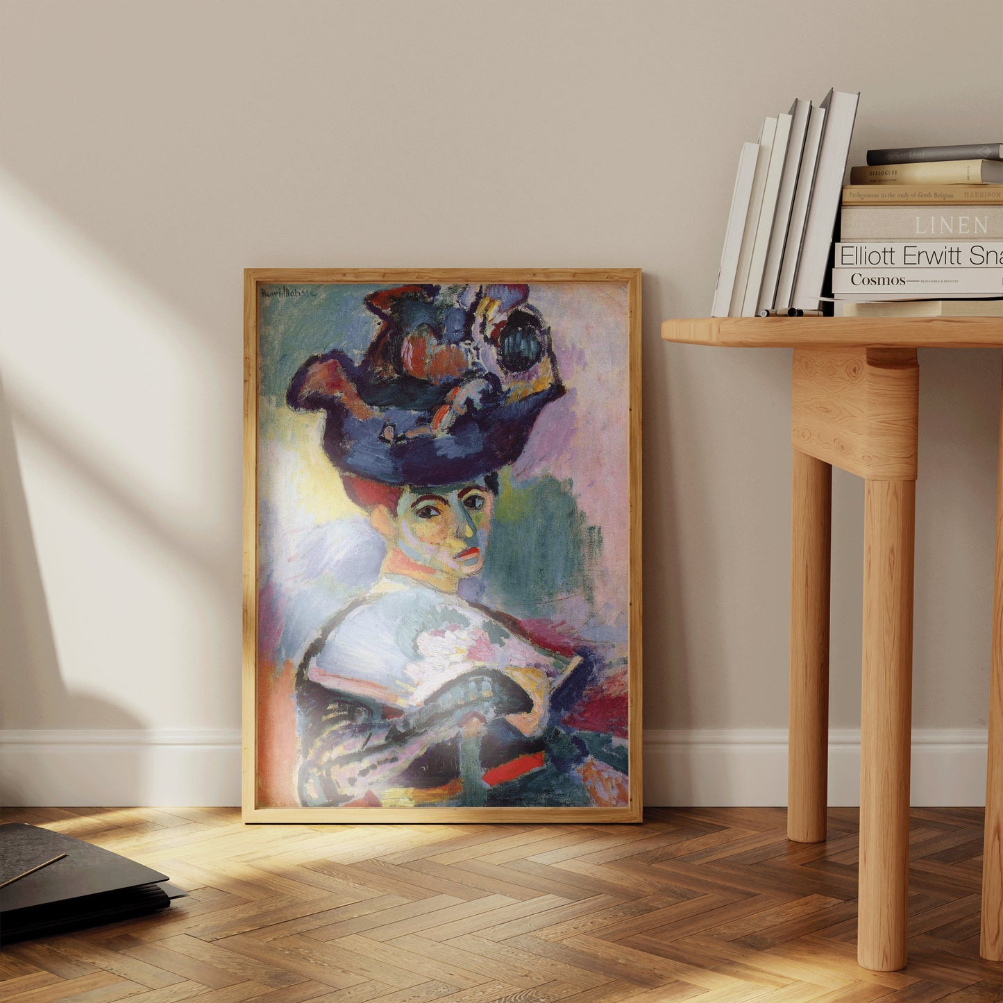 Henri Matisse's "Woman with a Hat" framed art print leaning against a wall, enhancing home decor with vibrant museum-quality colors.