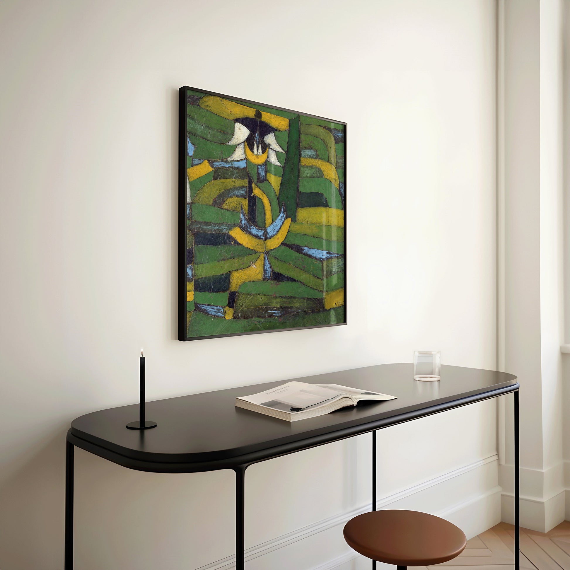 Paul Klee White Blossom in the Garden, green abstract art print, framed on wall above minimalist black desk with book and cup.