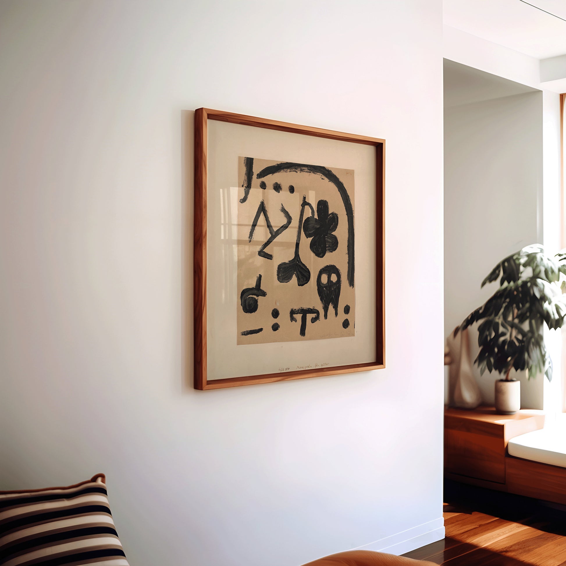 Vintage mid-century modern abstract art print by Paul Klee in beige, displayed on a wall in a stylish living room, framed.