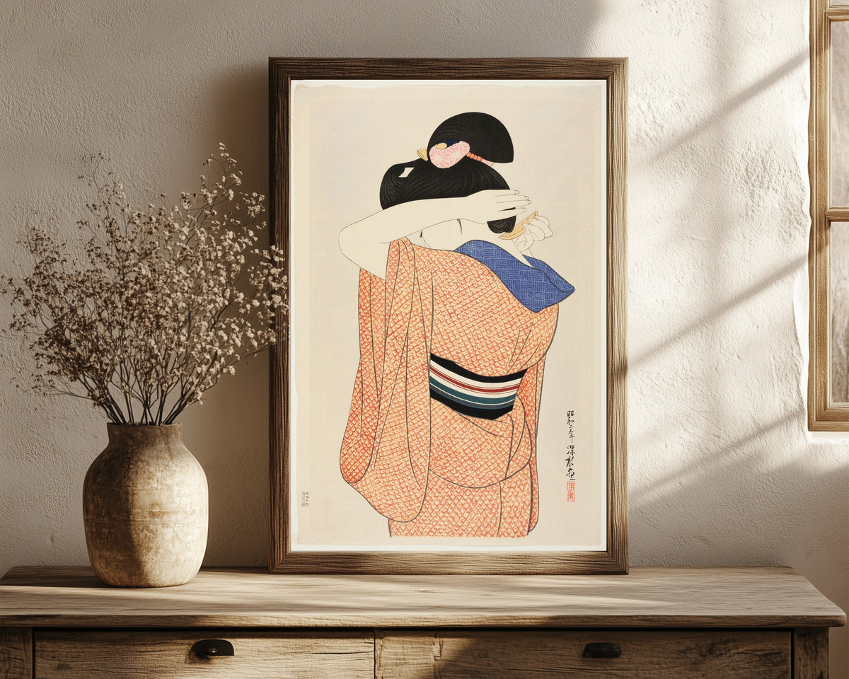 Framed art print of The Long Undergarment by Ito Shinsui, in a dark wood frame leaning on a rustic console beside dried flowers