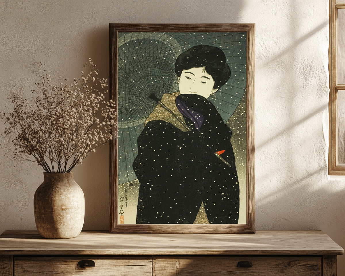 Framed art print of Snowy Night by Ito Shinsui, in a dark wood frame leaning on a rustic console beside dried flowers