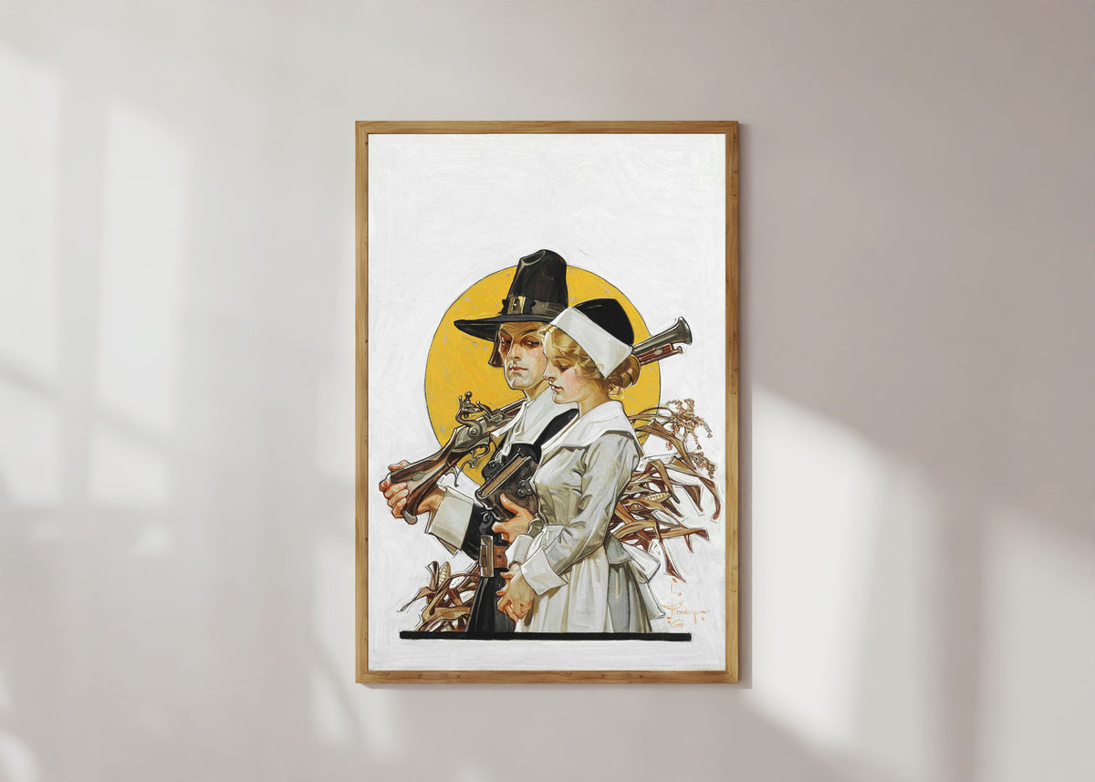 Framed art print of Giving Thanks (Thanksgiving Couple) by J.C. Leyendecker, in a light wood frame on a sunlit white wall