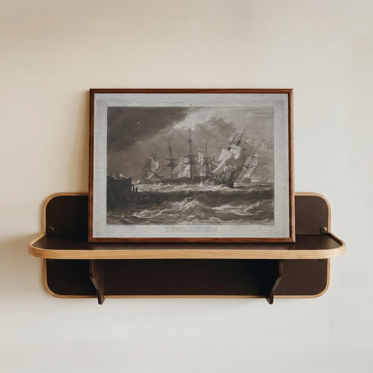 Framed art print of Liber Studiorum: Ships in a Breeze by J.M.W. Turner, in a dark wood frame resting on a wall shelf
