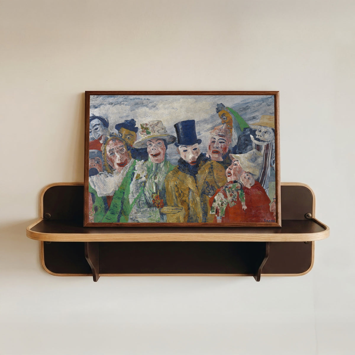 Framed art print of The Intrigue by James Ensor, in a dark wood frame resting on a wall shelf