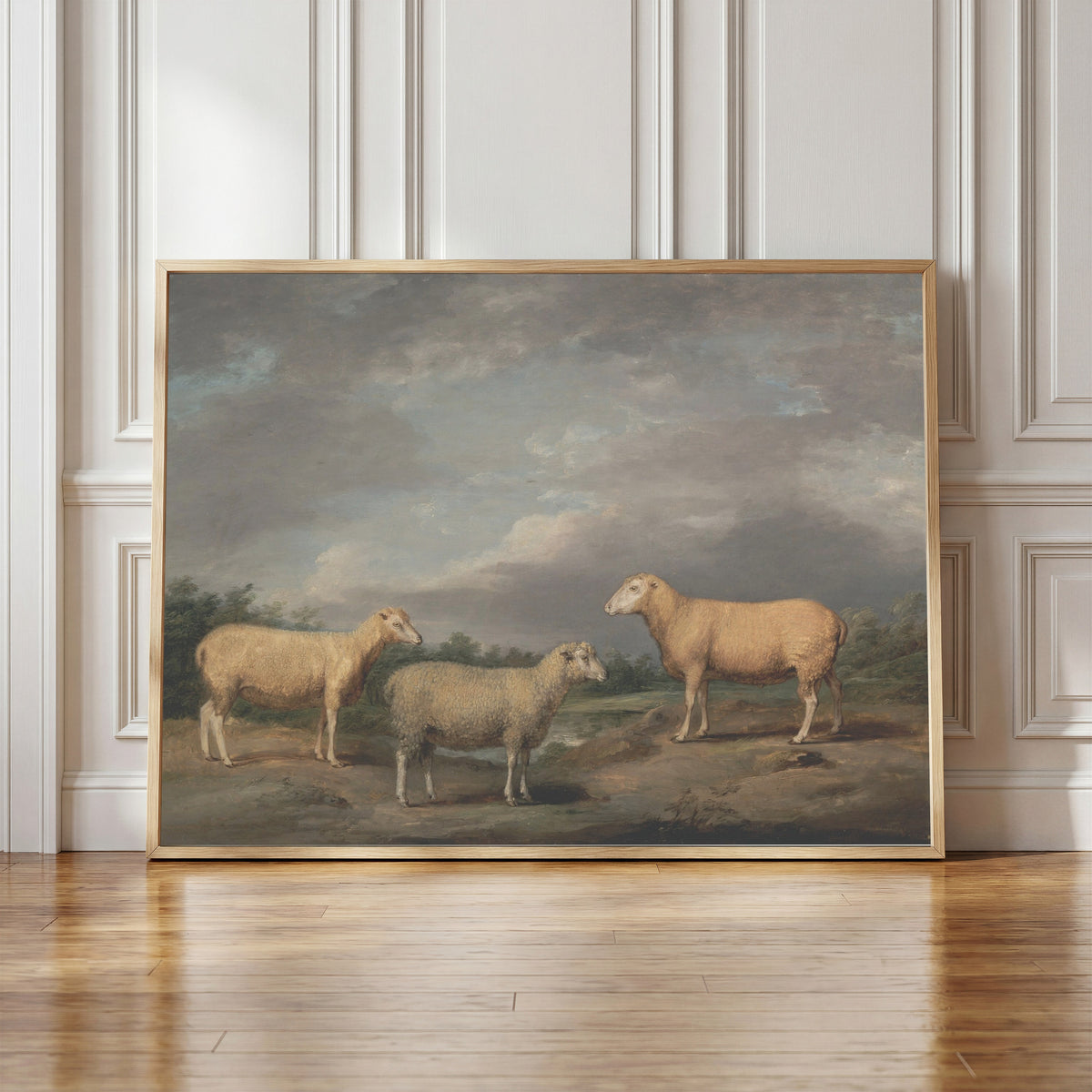 Framed art print of Ryelands Sheep by James Ward, in a light wood frame leaning against a panelled white wall