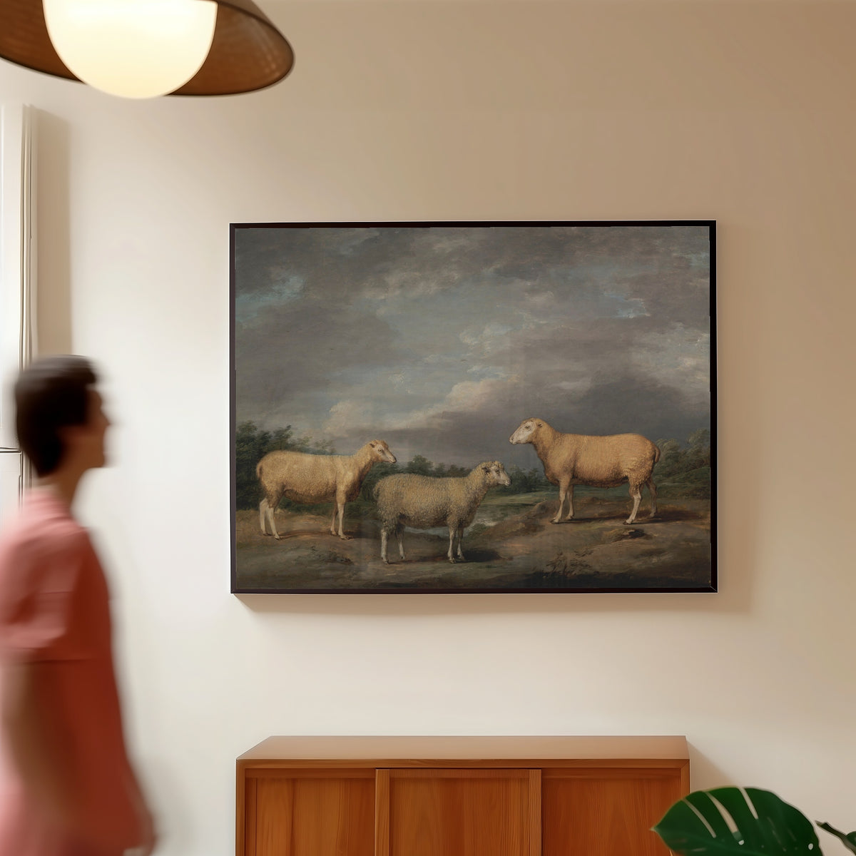 Framed art print of Ryelands Sheep by James Ward, in a slim black frame on a warm wall in a sunlit room
