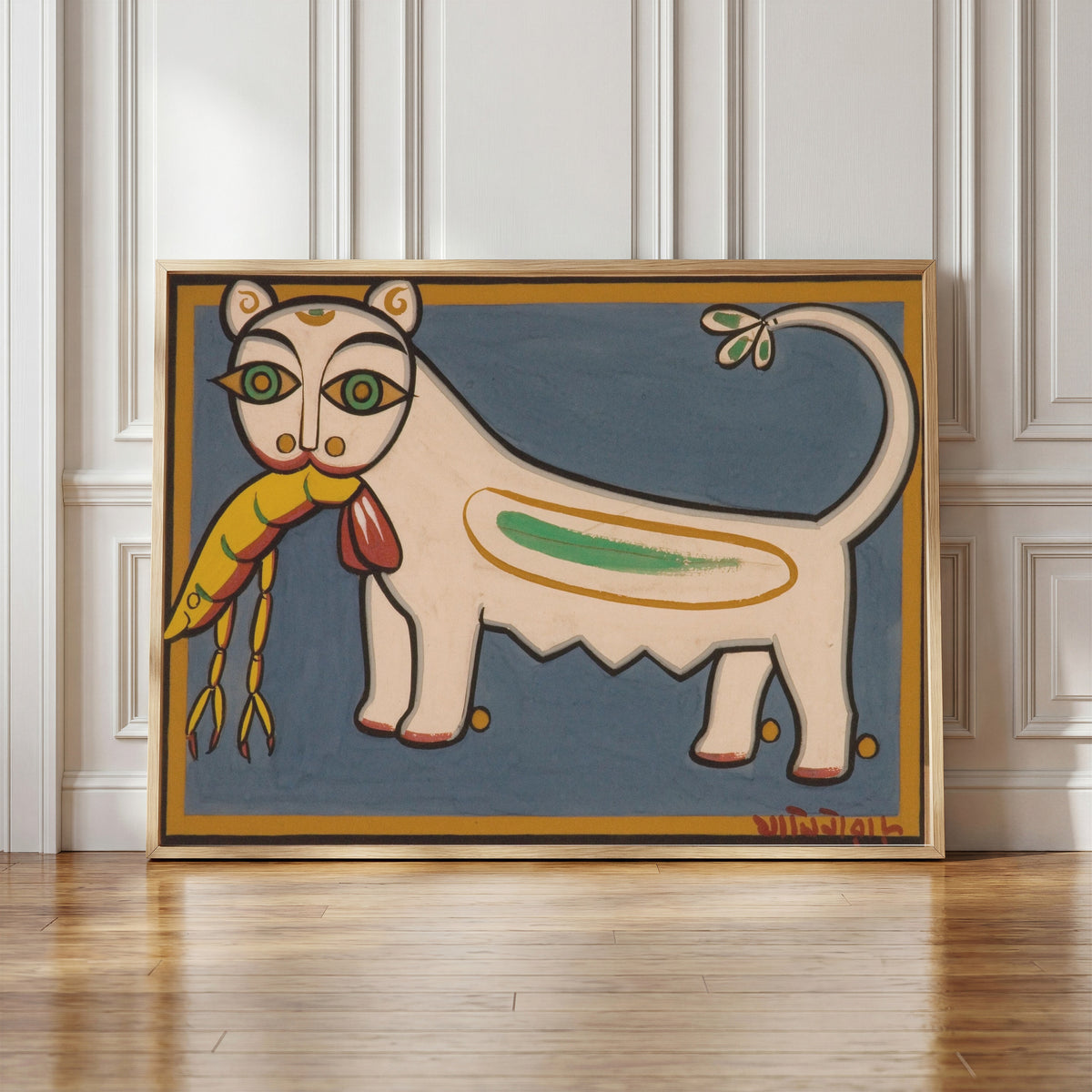 Framed art print of Cat and Shrimp by Jamini Roy, in a light wood frame leaning against a panelled white wall