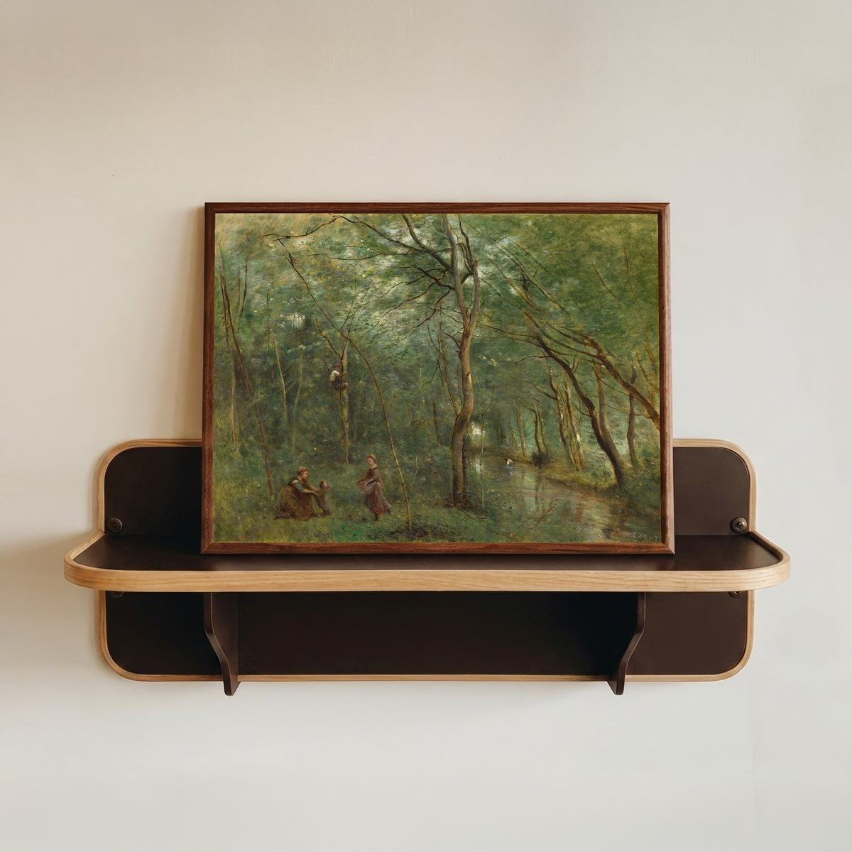 Framed art print of The Eel Gatherers by Jean-Baptiste-Camille Corot, in a dark wood frame resting on a wall shelf