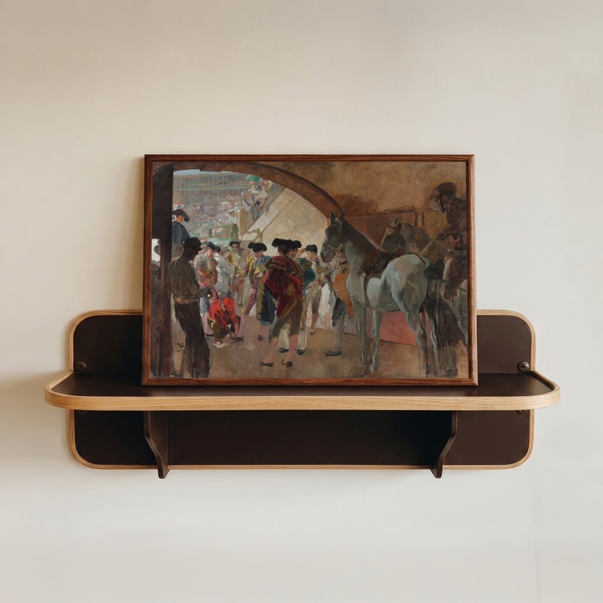 Framed art print of Before the Bullfight (Antes de la corrida) by Joaquín Sorolla, in a dark wood frame resting on a wall shelf