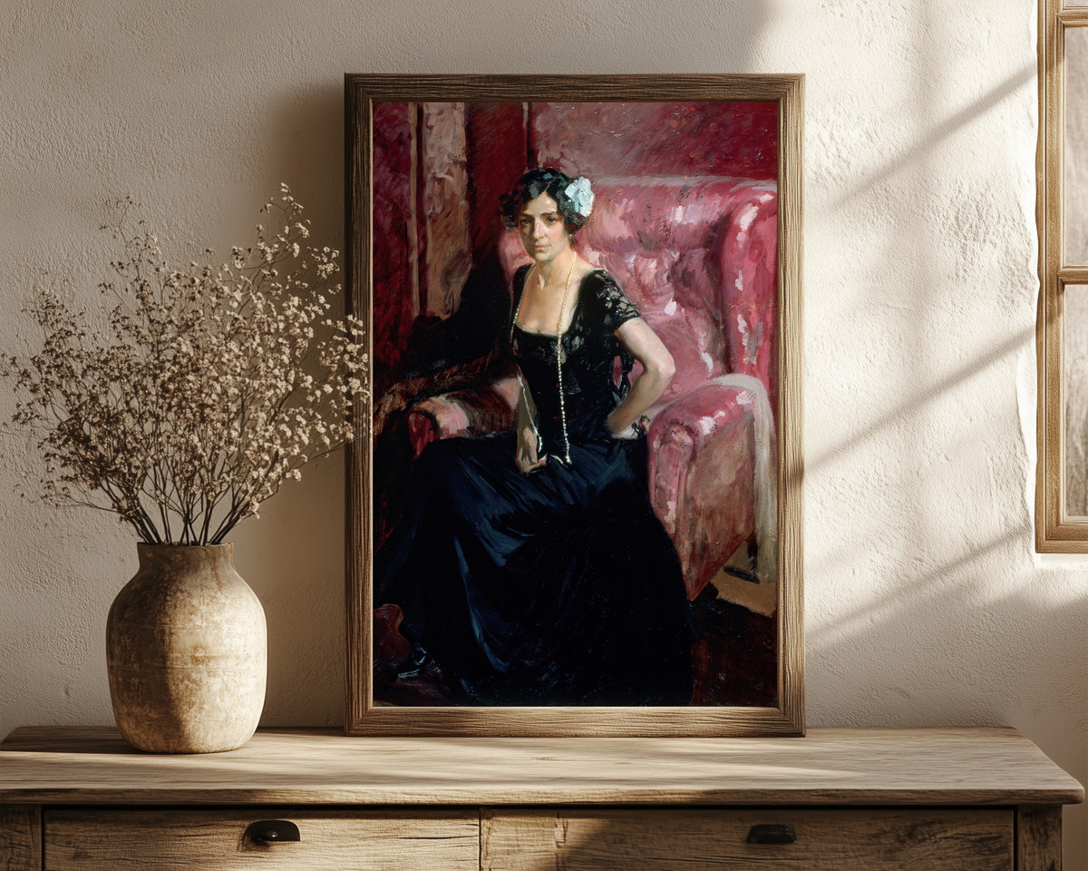 Framed art print of Clotilde in Evening Dress by Joaquín Sorolla, in a dark wood frame leaning on a rustic console beside dried flowers