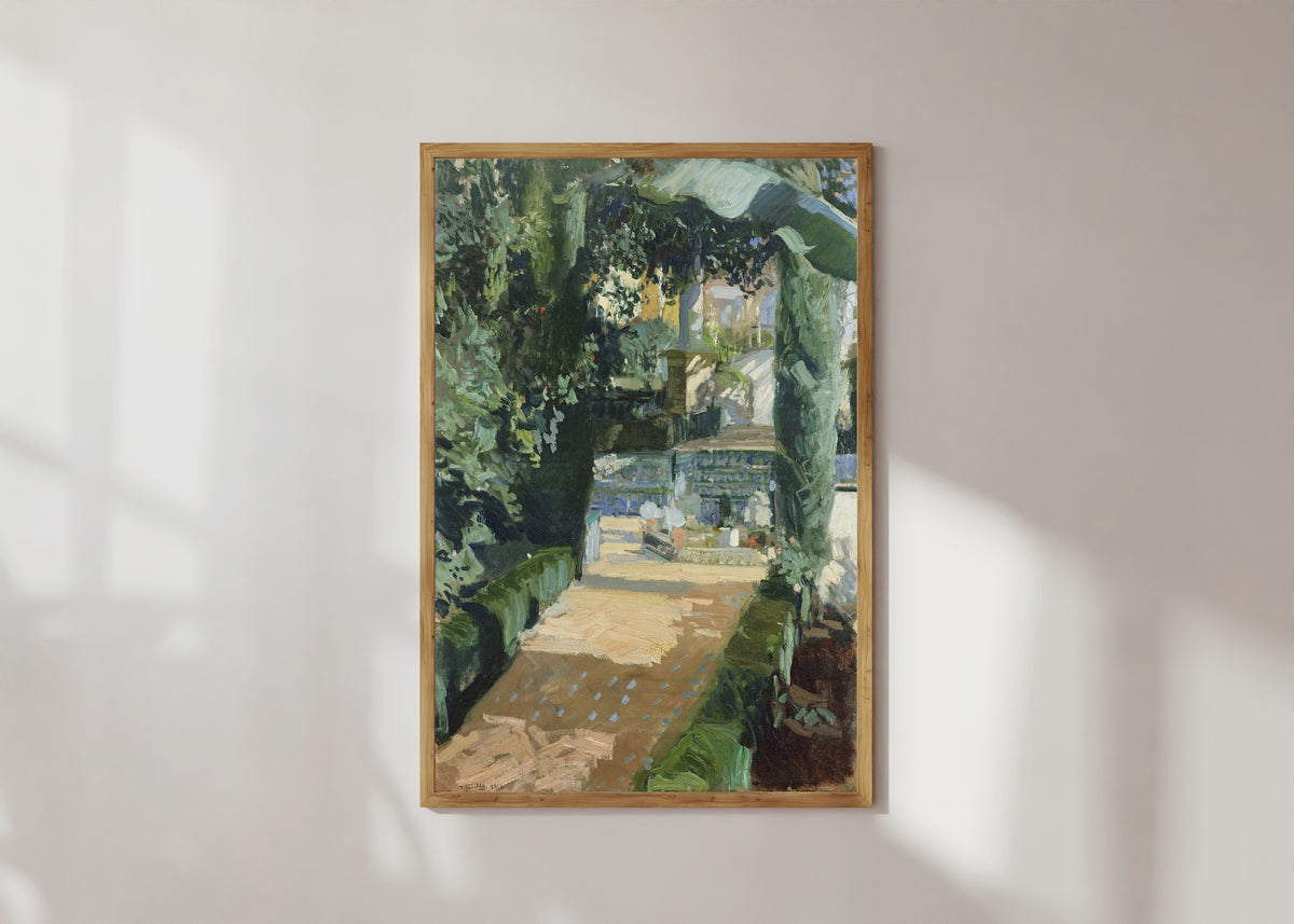 Framed art print of Court of the Dances, Alcázar of Seville by Joaquín Sorolla, in a light wood frame on a sunlit white wall