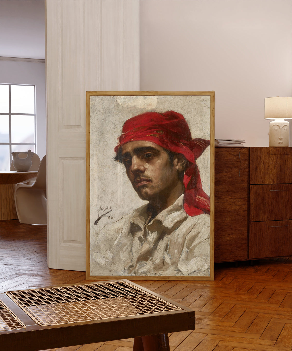 Framed art print of El Palleter by Joaquín Sorolla, in a light wood frame leaning in a warm room with a parquet floor