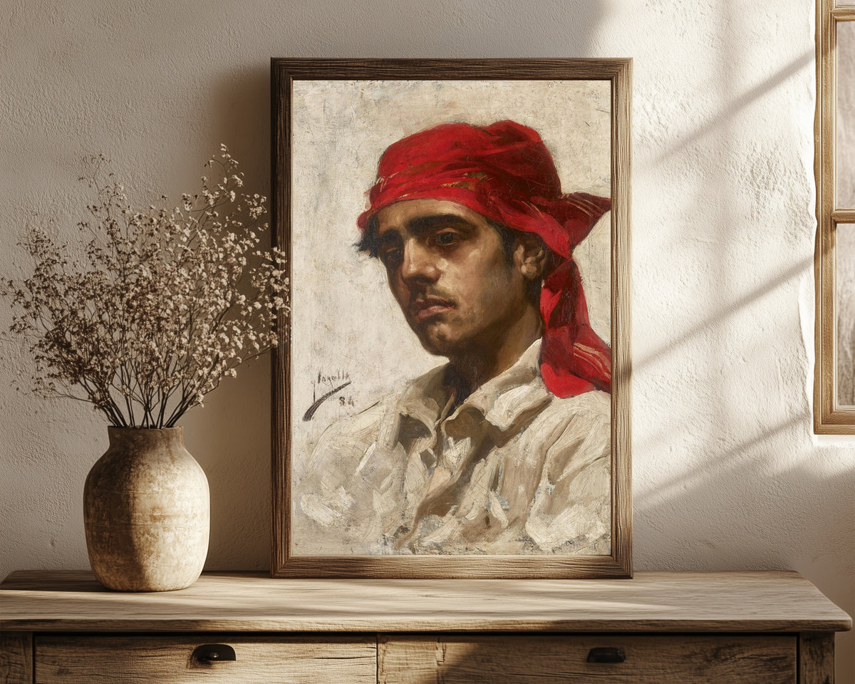 Framed art print of El Palleter by Joaquín Sorolla, in a dark wood frame leaning on a rustic console beside dried flowers
