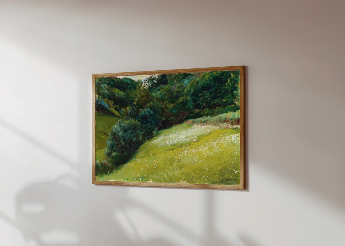 Framed art print of Field in Asturias, San Esteban de Pravia by Joaquín Sorolla, in a light wood frame on a sunlit white wall, seen at a slight angle