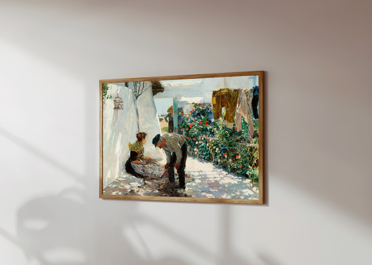 Framed art print of Fishing Nets (Las redes) by Joaquín Sorolla, in a light wood frame on a sunlit white wall, seen at a slight angle