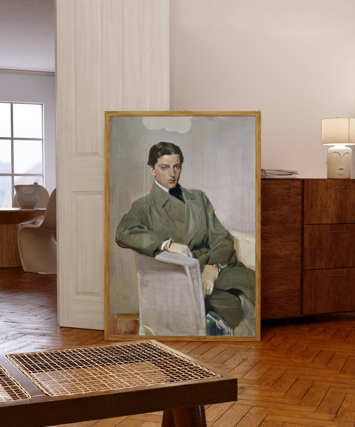 Framed art print of Joaquín by Joaquín Sorolla, in a light wood frame leaning in a warm room with a parquet floor