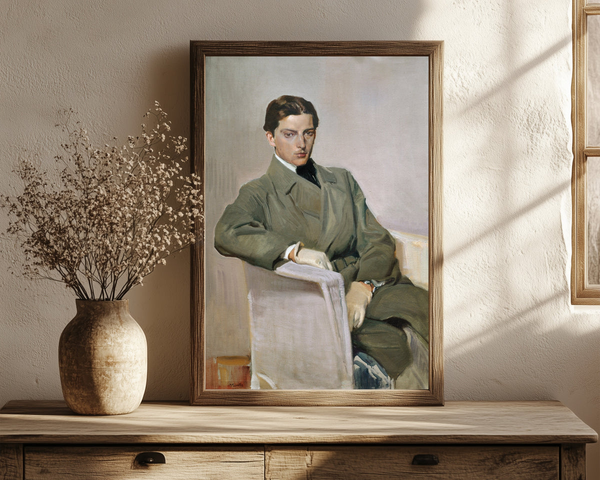 Framed art print of Joaquín by Joaquín Sorolla, in a dark wood frame leaning on a rustic console beside dried flowers