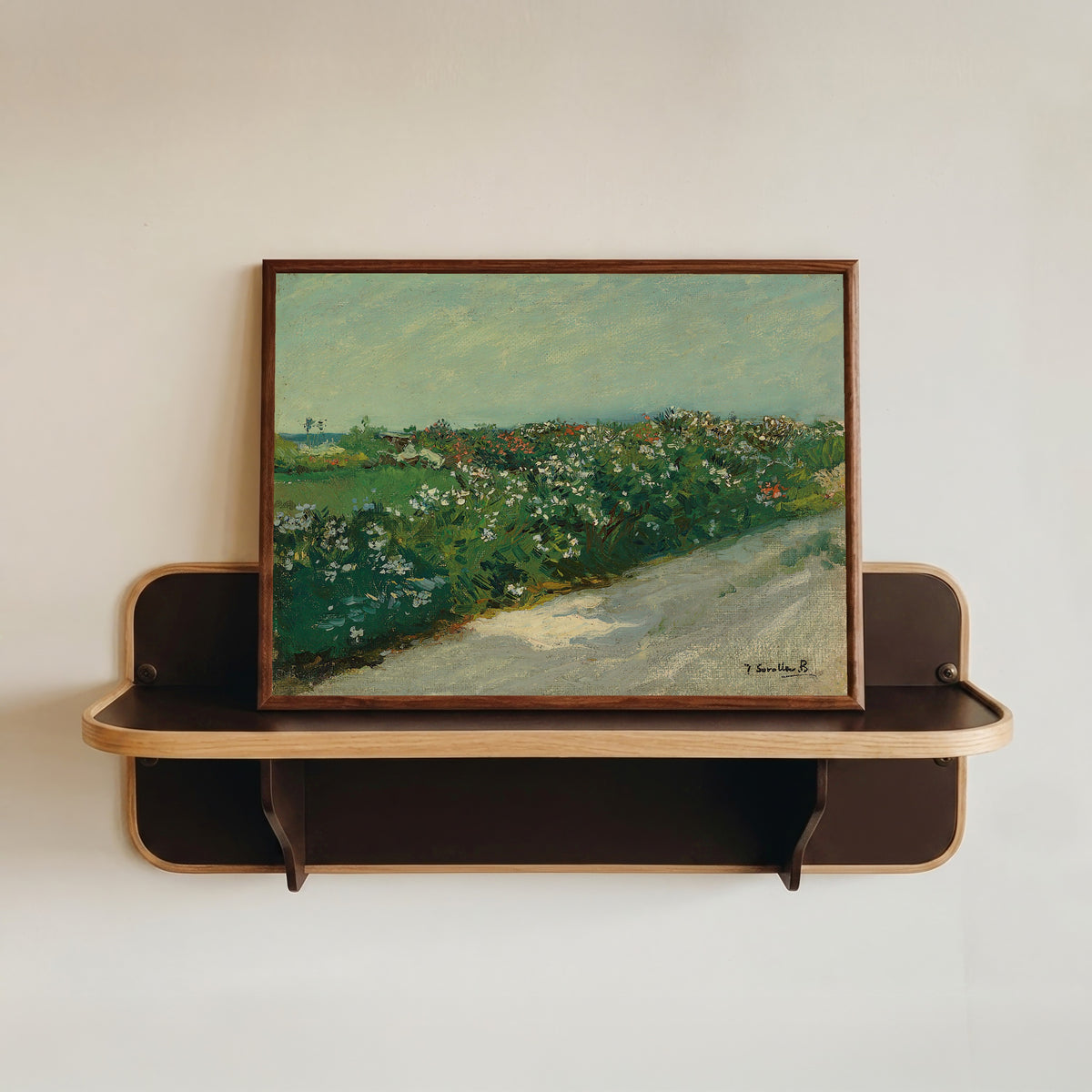 Framed art print of Malvarrosa by Joaquín Sorolla, in a dark wood frame resting on a wall shelf