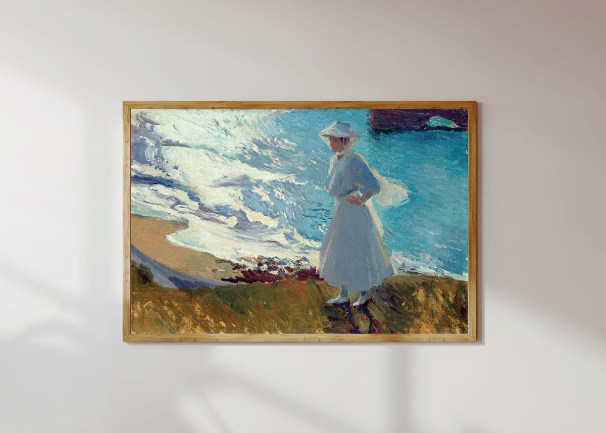 Framed art print of María on the Beach at Biarritz (Contre-jour) by Joaquín Sorolla, in a light wood frame on a sunlit white wall