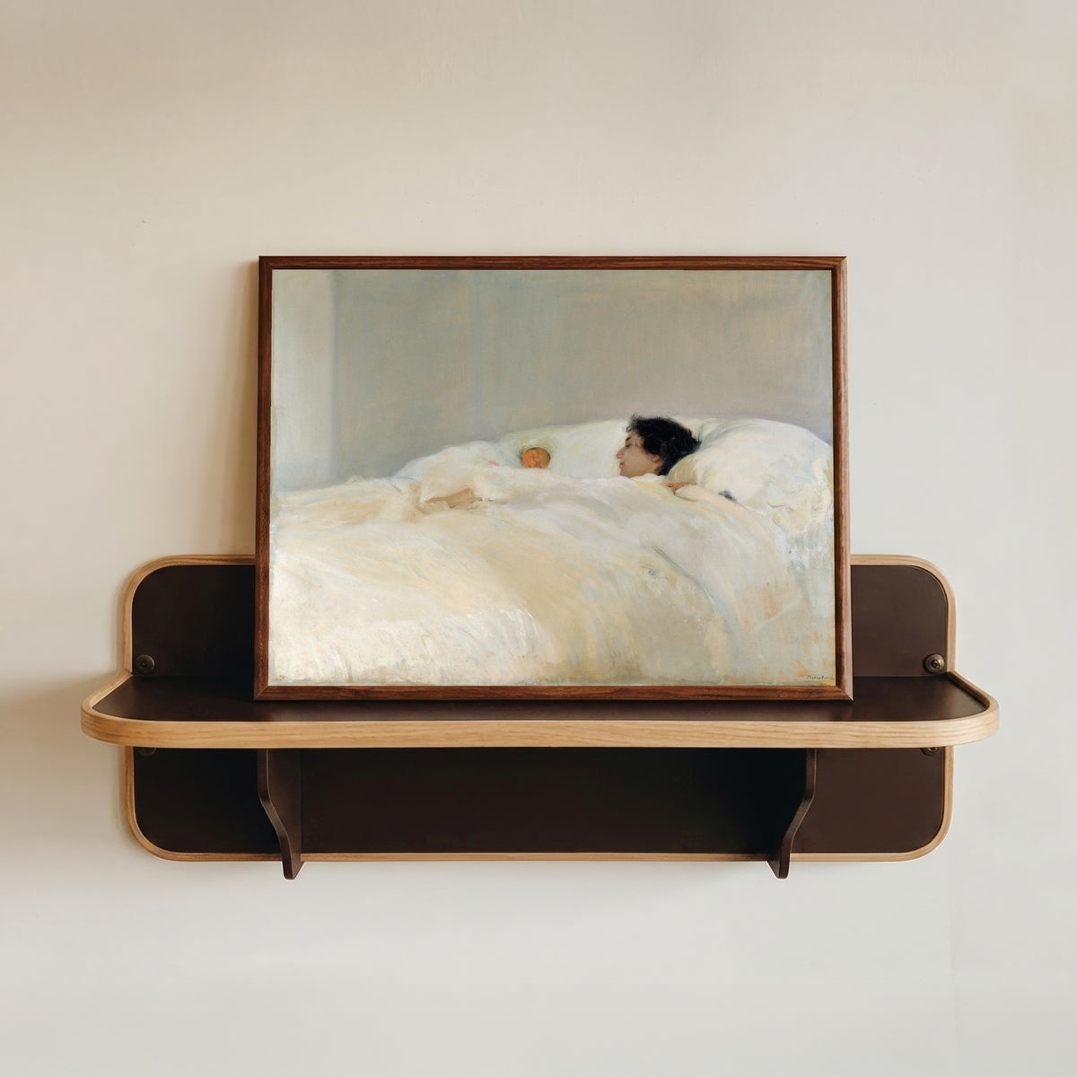 Framed art print of Mother by Joaquín Sorolla, in a dark wood frame resting on a wall shelf