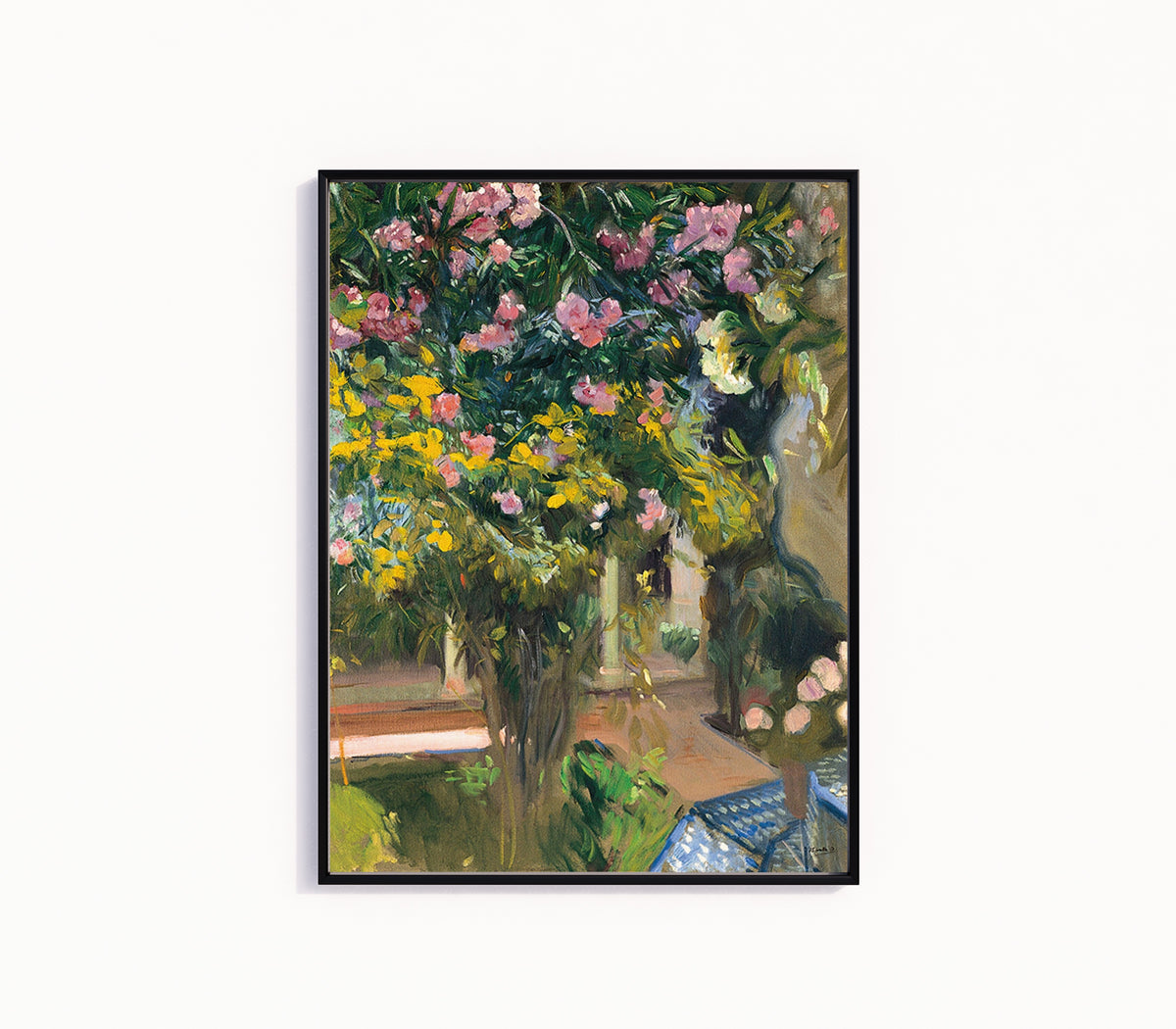 Framed art print of Oleanders in the Courtyard of the Artist's House by Joaquín Sorolla, in a slim black frame on a plain white wall