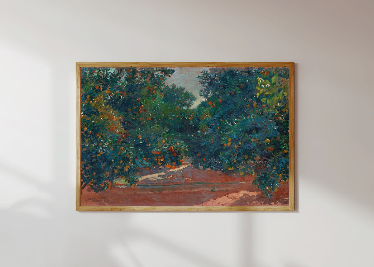 Framed art print of Orange Trees in Alcira by Joaquín Sorolla, in a light wood frame on a sunlit white wall