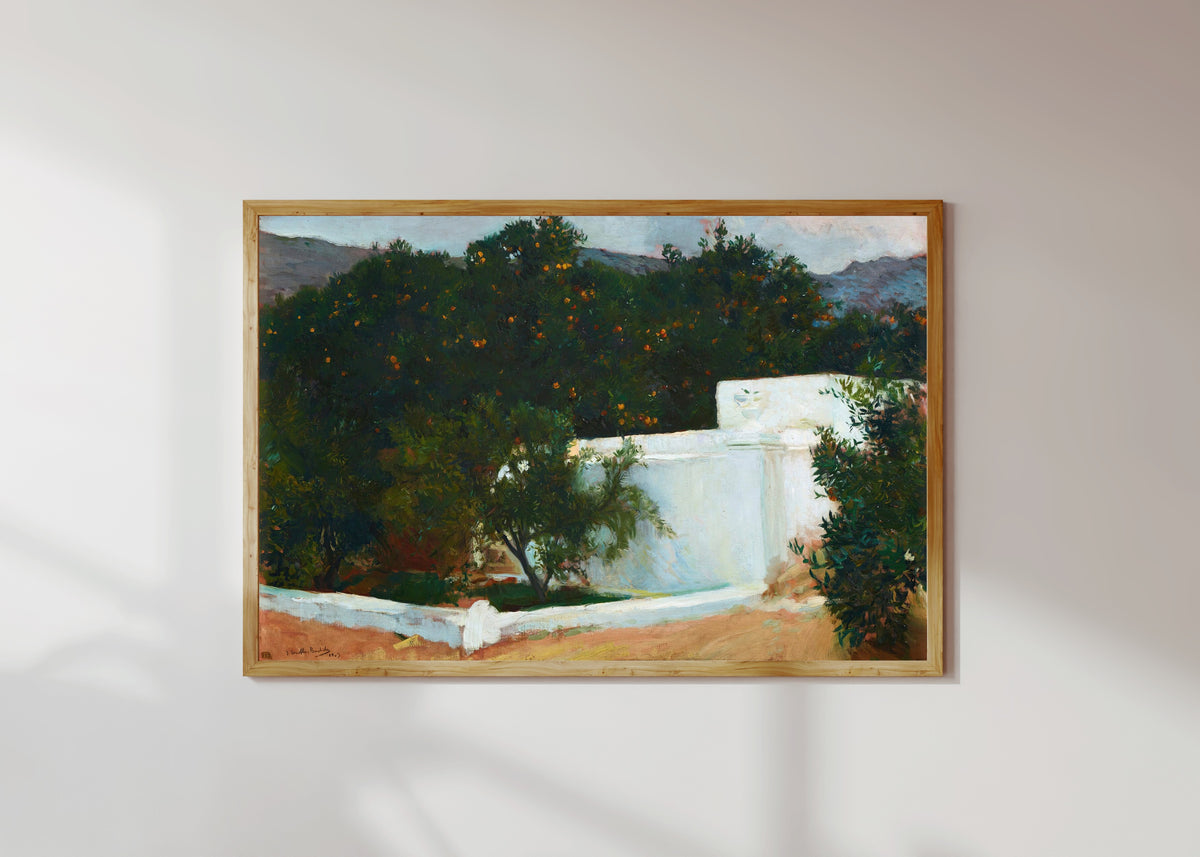 Framed art print of Orange Trees on the Road to the Sea, Valencia by Joaquín Sorolla, in a light wood frame on a sunlit white wall