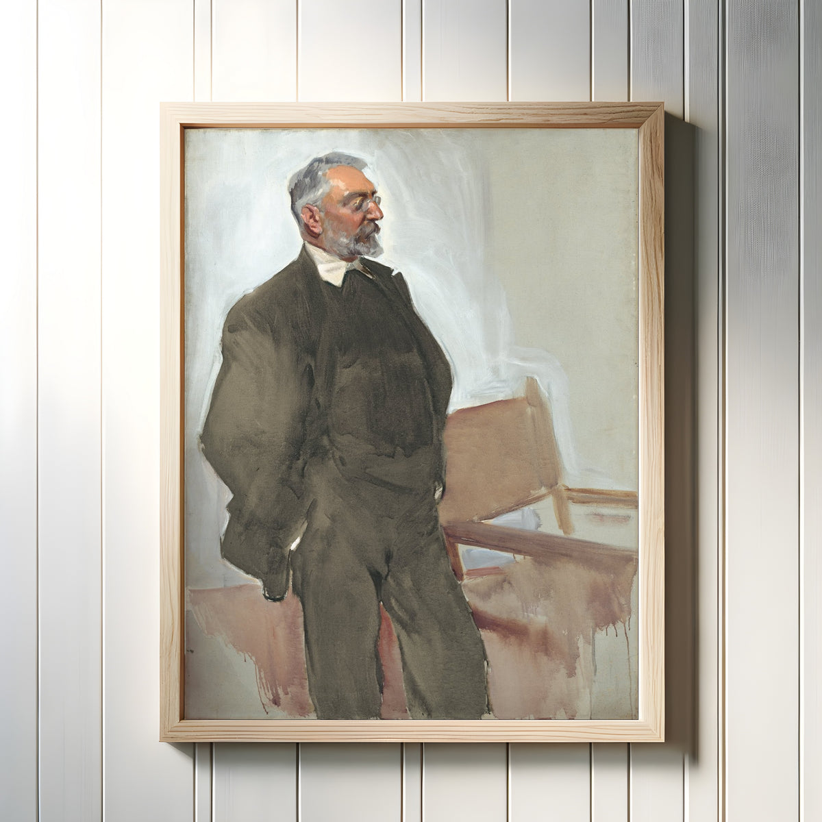 Framed art print of Portrait of Miguel de Unamuno by Joaquín Sorolla, in a light wood frame on a white panelled wall
