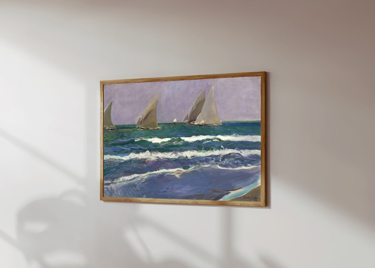 Framed art print of Sails at Sea, Valencia (Velas en el mar) by Joaquín Sorolla, in a light wood frame on a sunlit white wall, seen at a slight angle