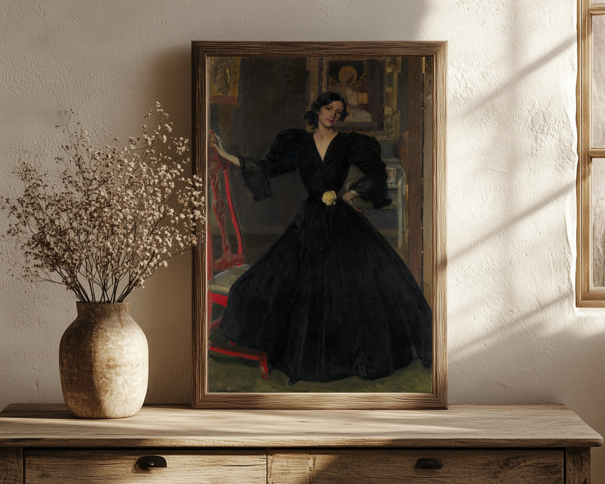 Framed art print of Señora de Sorolla in Black by Joaquín Sorolla, in a dark wood frame leaning on a rustic console beside dried flowers