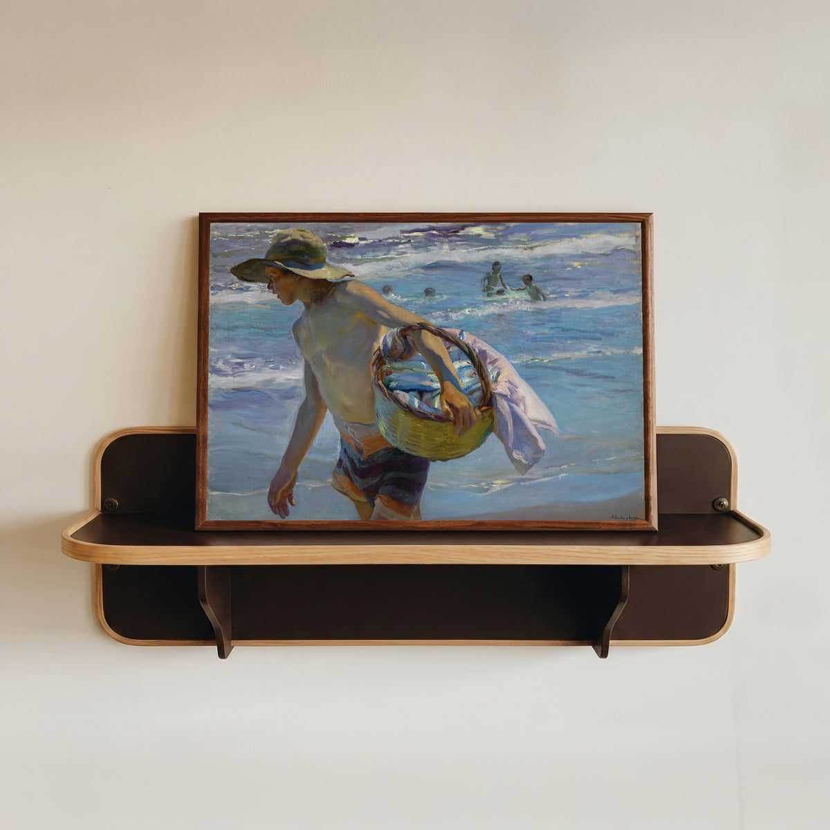 Framed art print of The Fisherman (El Pescador) by Joaquín Sorolla, in a dark wood frame resting on a wall shelf