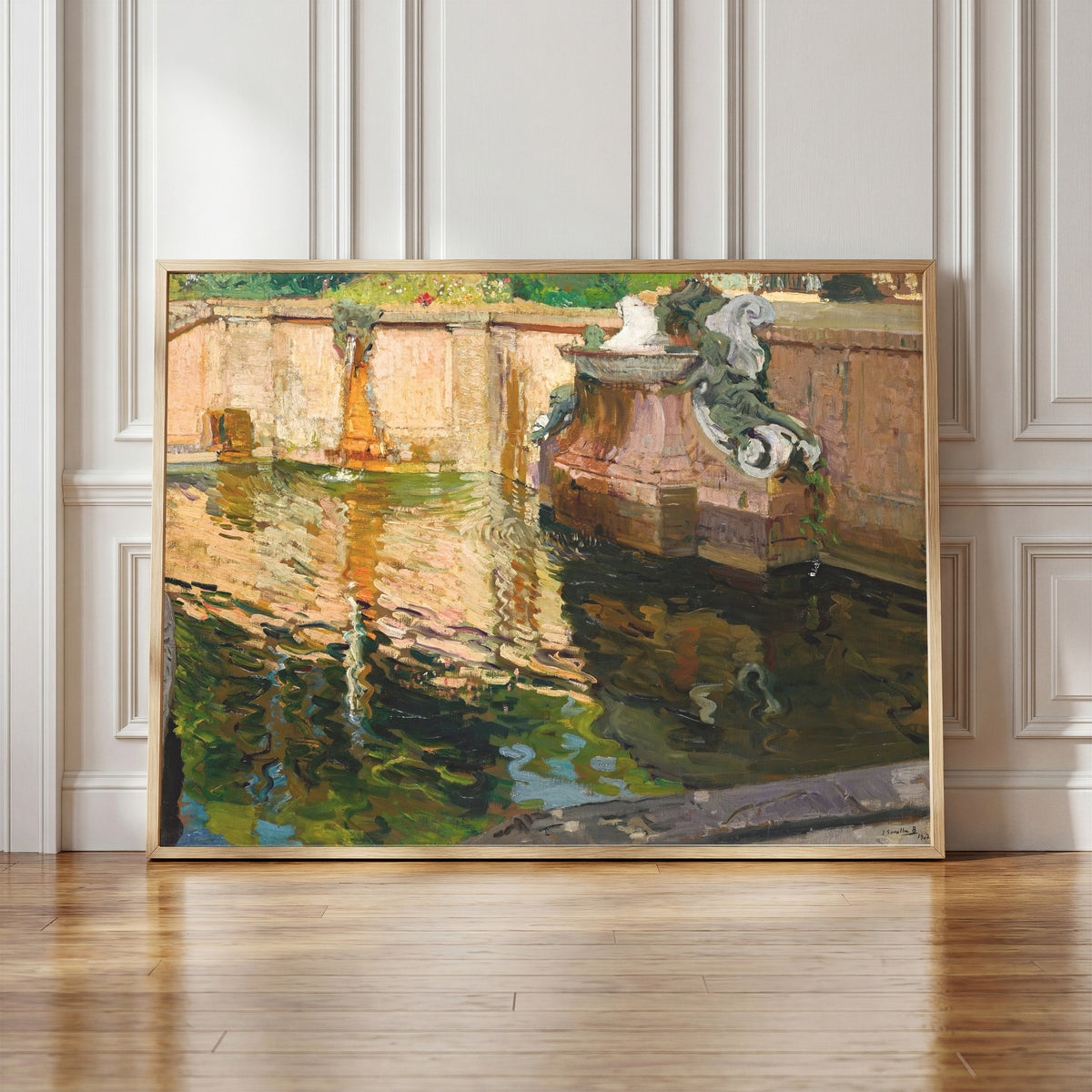 Framed art print of The Horses Fountain, La Granja by Joaquín Sorolla, in a light wood frame leaning against a panelled white wall