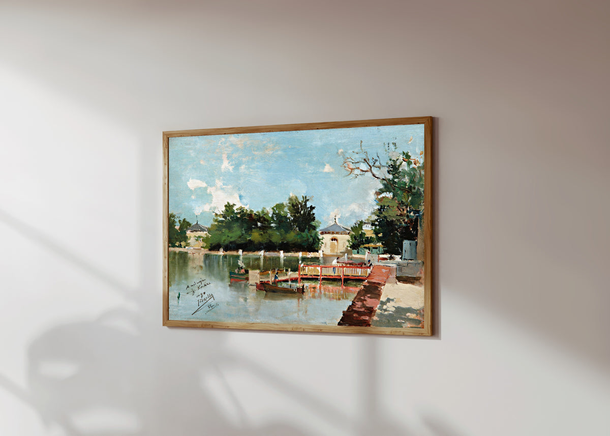 Framed art print of The Jetty in the Retiro Gardens, Madrid by Joaquín Sorolla, in a light wood frame on a sunlit white wall, seen at a slight angle
