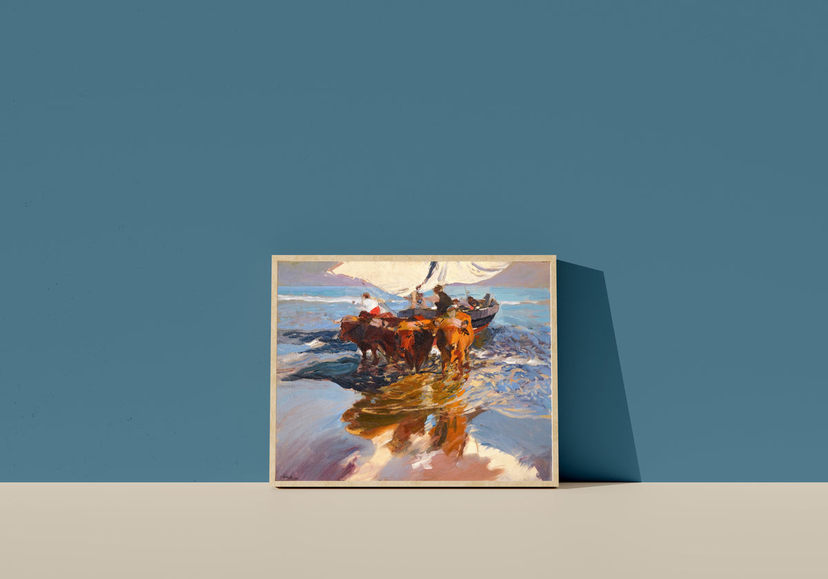 Framed art print of The Return from Fishing, Valencia Beach by Joaquín Sorolla, in a light wood frame leaning on a blue wall