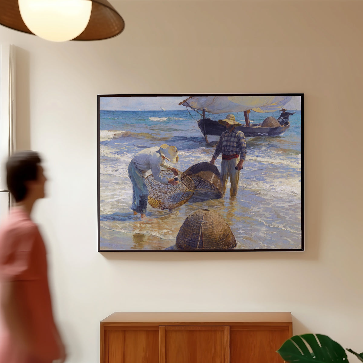 Framed art print of Valencian Fishermen by Joaquín Sorolla, in a slim black frame on a warm wall in a sunlit room