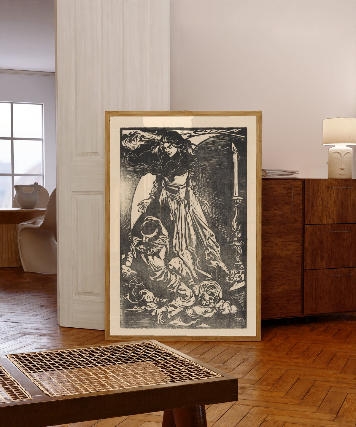 Framed art print of Vrouw met maansikkel [Woman with crescent… by Johannes Josephus Aarts, in a light wood frame leaning in a warm room with a parquet floor