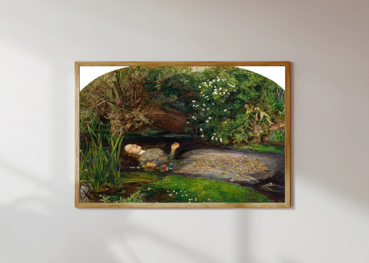 Framed art print of Ophelia by John Everett Millais, in a light wood frame on a sunlit white wall