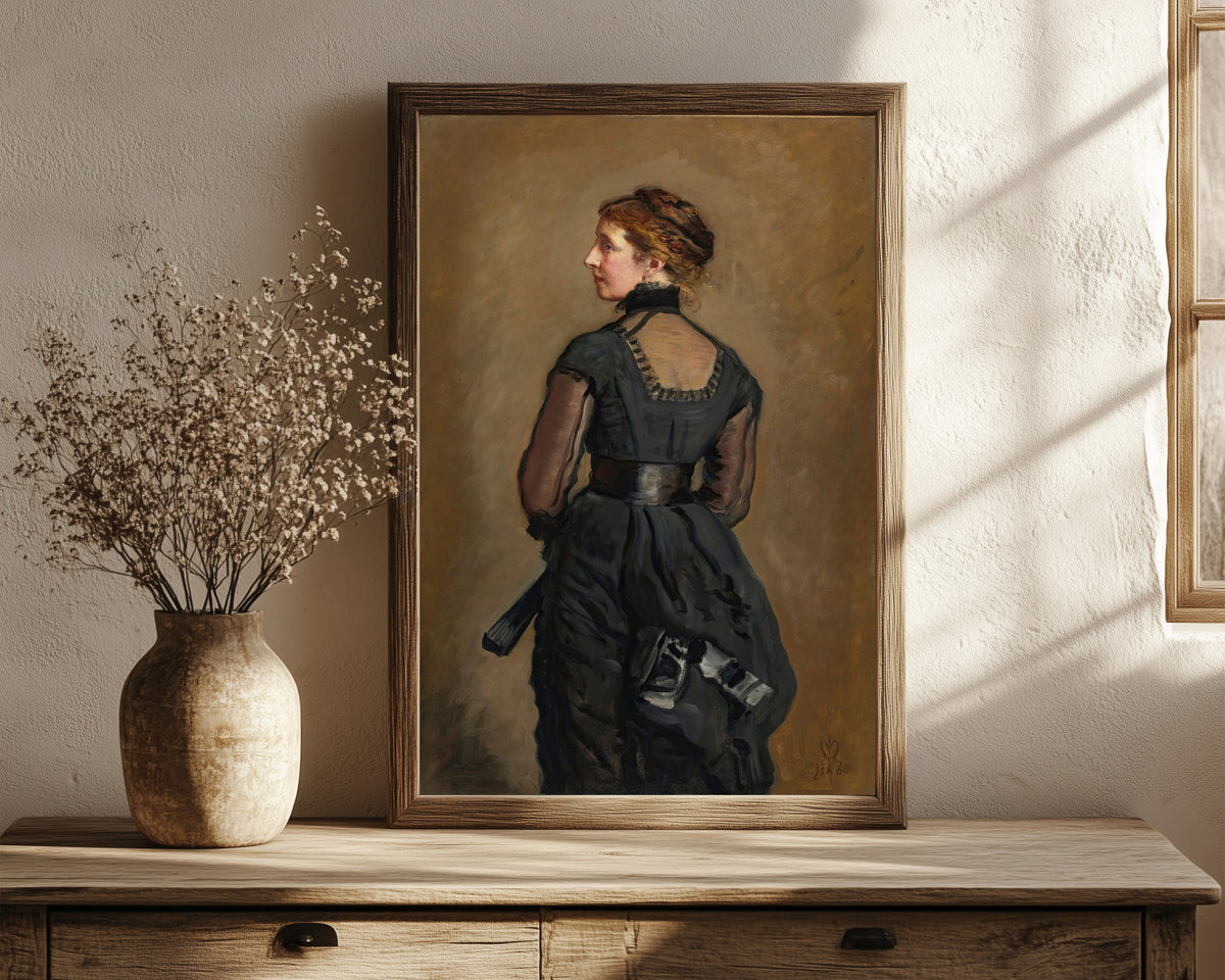 Framed art print of Portrait of Kate Perugini, Daughter of… by John Everett Millais, in a dark wood frame leaning on a rustic console beside dried flowers