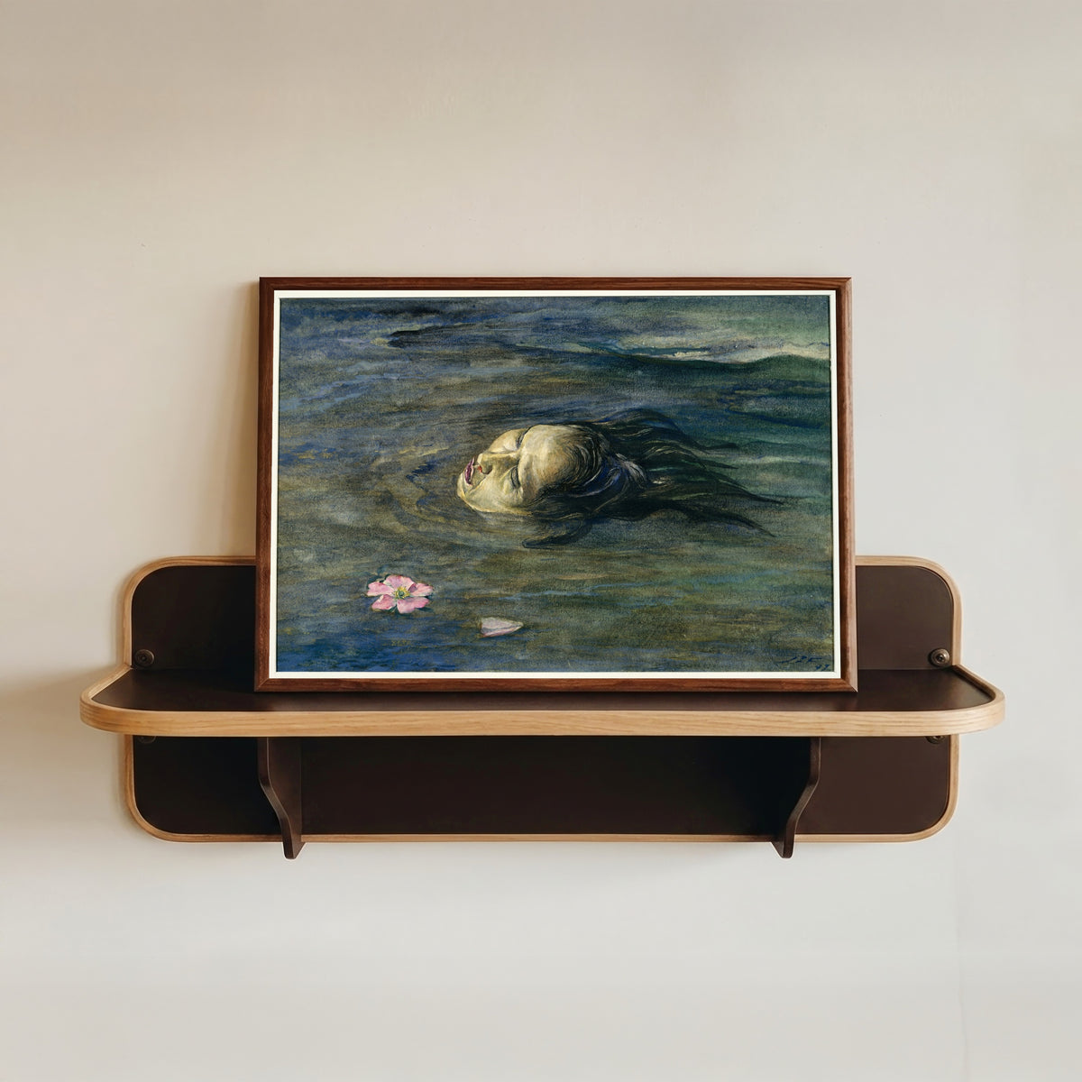 Framed art print of The Strange Thing Little Kiosai Saw in the River by John La Farge, in a dark wood frame resting on a wall shelf