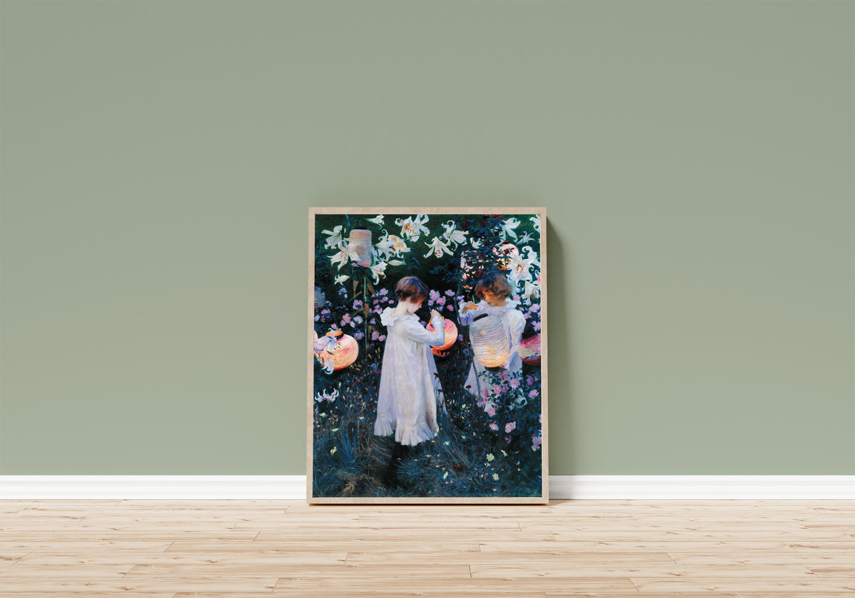 Framed art print of Carnation, Lily, Lily, Rose by John Singer Sargent, in a light wood frame leaning on a sage green wall above a wooden floor