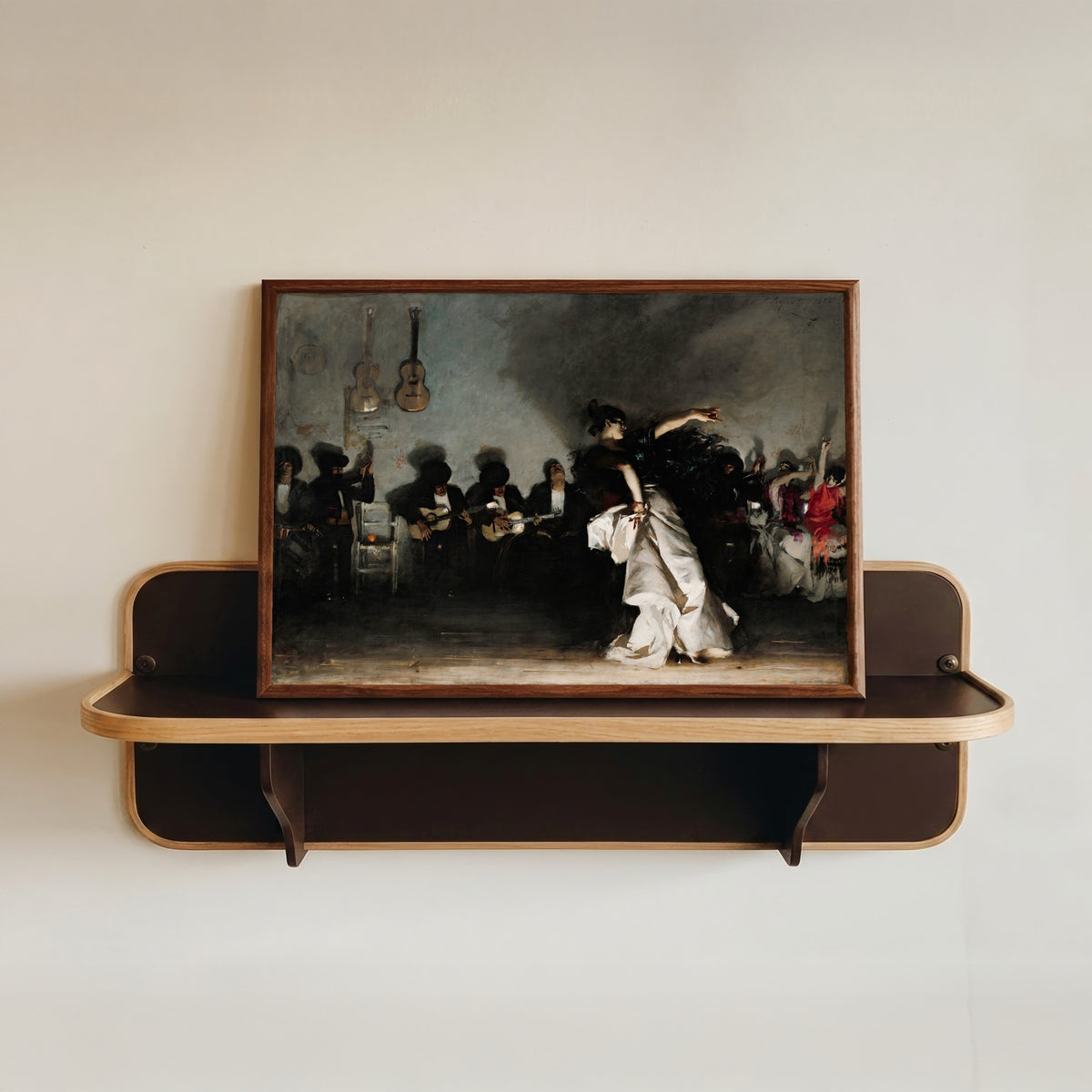 Framed art print of El Jaleo by John Singer Sargent, in a dark wood frame resting on a wall shelf