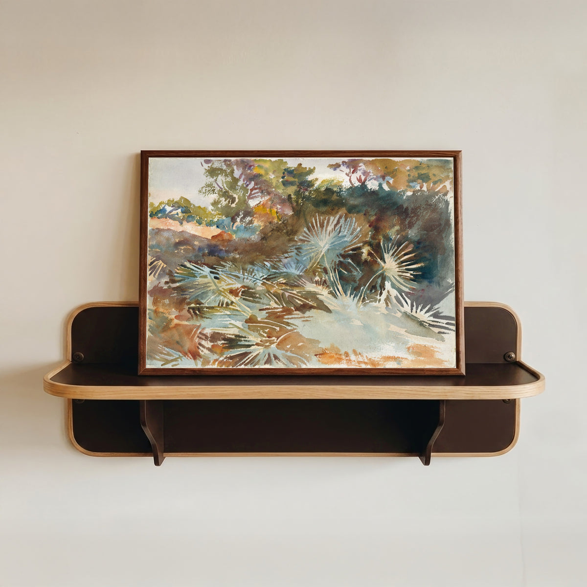 Framed art print of Landscape with Palmettos by John Singer Sargent, in a dark wood frame resting on a wall shelf