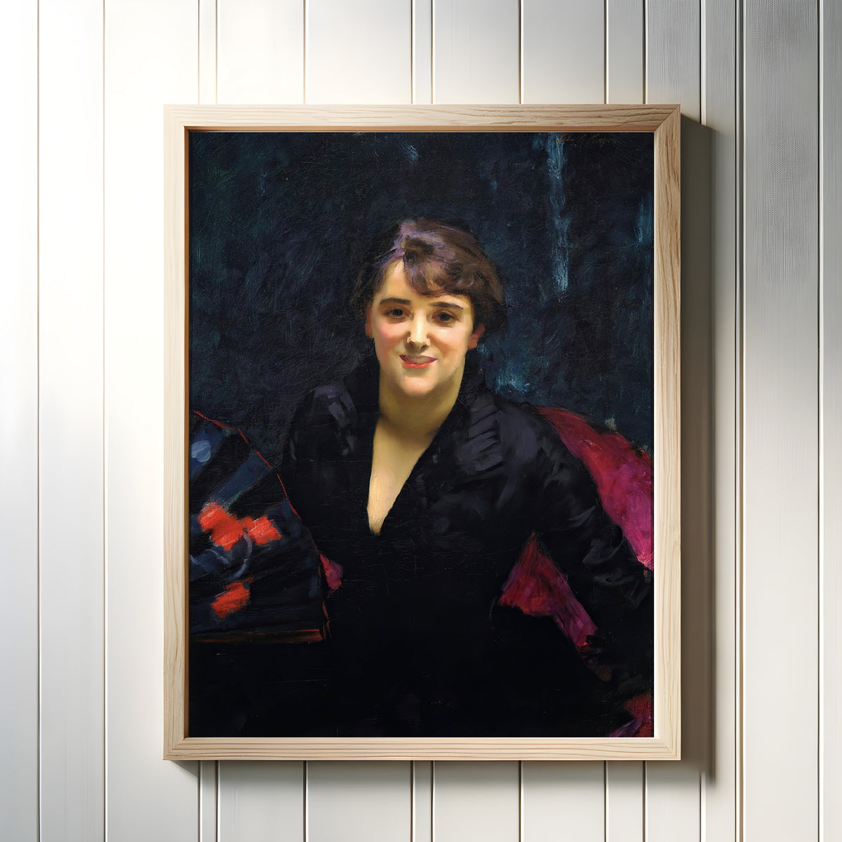 Framed art print of Madame Errázuriz (The Lady in Black) by John Singer Sargent, in a light wood frame on a white panelled wall