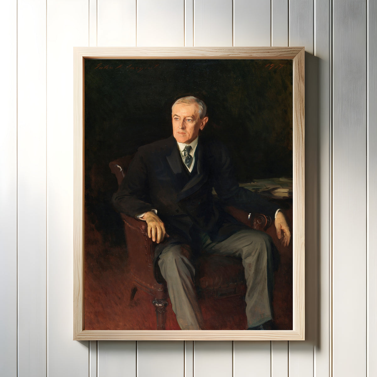 Framed art print of Portrait of Woodrow Wilson by John Singer Sargent, in a light wood frame on a white panelled wall